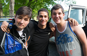 A group of teens at a college readiness program for teens with autism in Boston, Massachusetts standing in front of the group van. 